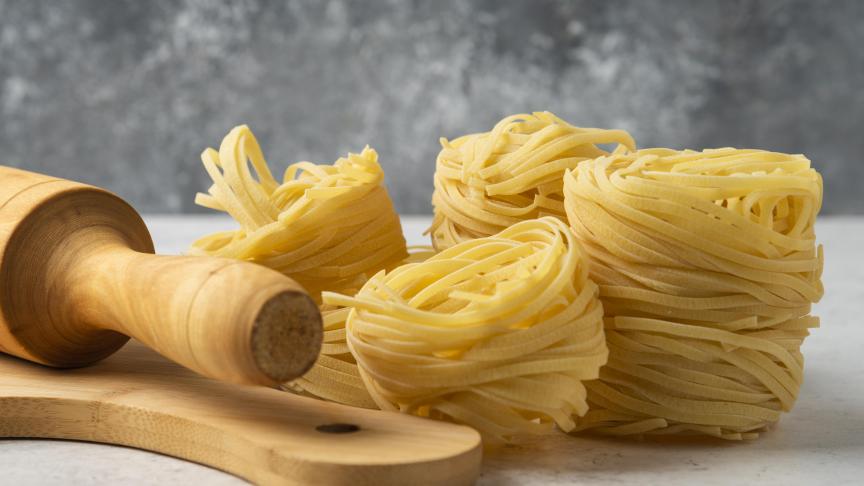 raw-pasta-nests-wooden-board-rolling-pin-white-table